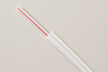 Load image into Gallery viewer, 10.25" white straw with a red stripe, halfway out of the white paper wrapper, on a counter