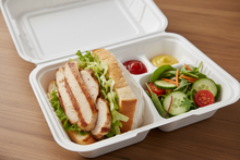 Load image into Gallery viewer, white hinged lid food takeout container, disposable, 3-compartment, with a chicken sandwich in the largest compartment, sauces in another compartment, and a small side salad in the third compartment