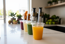 Load image into Gallery viewer, place a variety of juices with the same straw in their clear cups in the background, change the countertop to that of a juice shop
